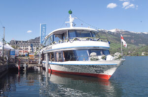 A white tourist boat named 'Schmittenhöhe' at the pier. | © Studio Ehringer GmbH